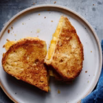 Lady crochets vibrant orange yarn around styrofoam cones. This is the smartest Easter prep idea I’ve seen